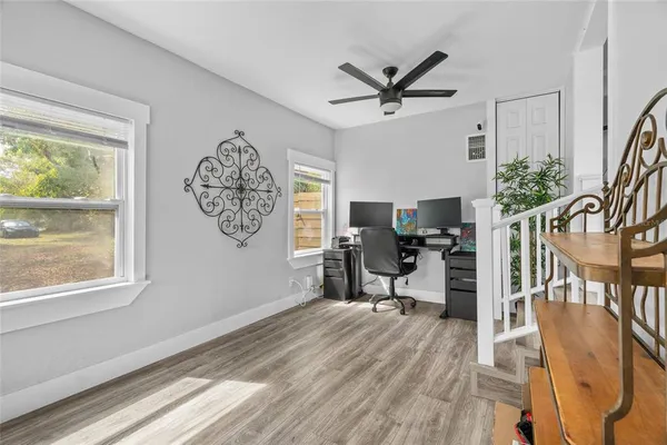 a view of a work space with furniture window and wooden floor