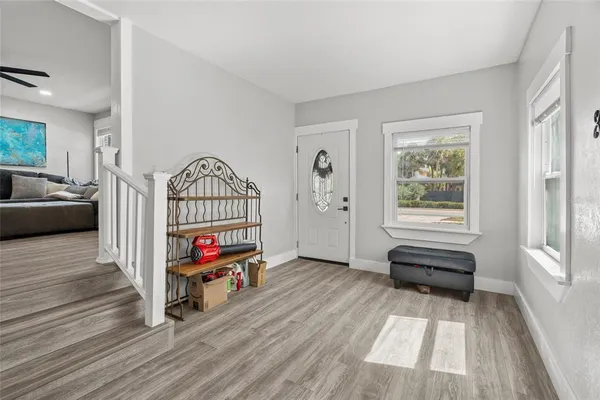 a view of front door with furniture and wooden floor