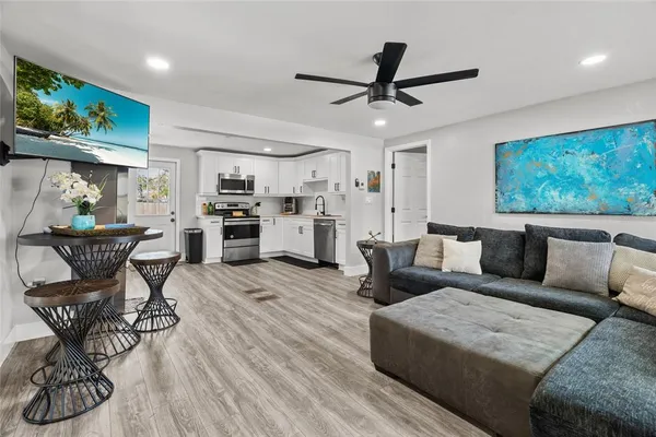 a living room with furniture and a chandelier