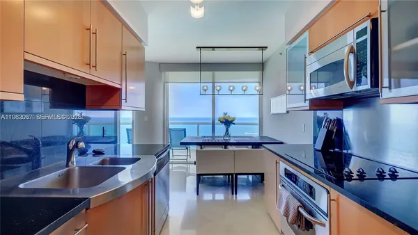a kitchen with stainless steel appliances granite countertop a sink stove and cabinets
