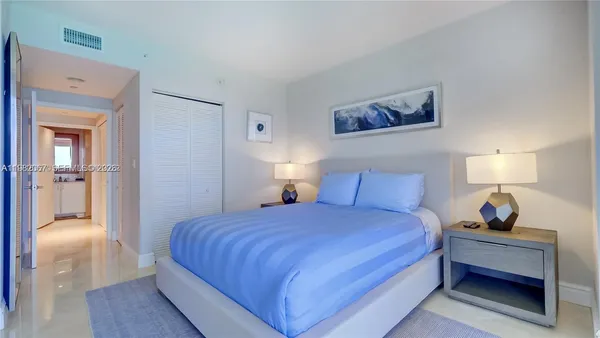 a bedroom with a bed and a lamp on table
