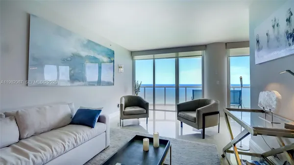 a living room with furniture and a large window