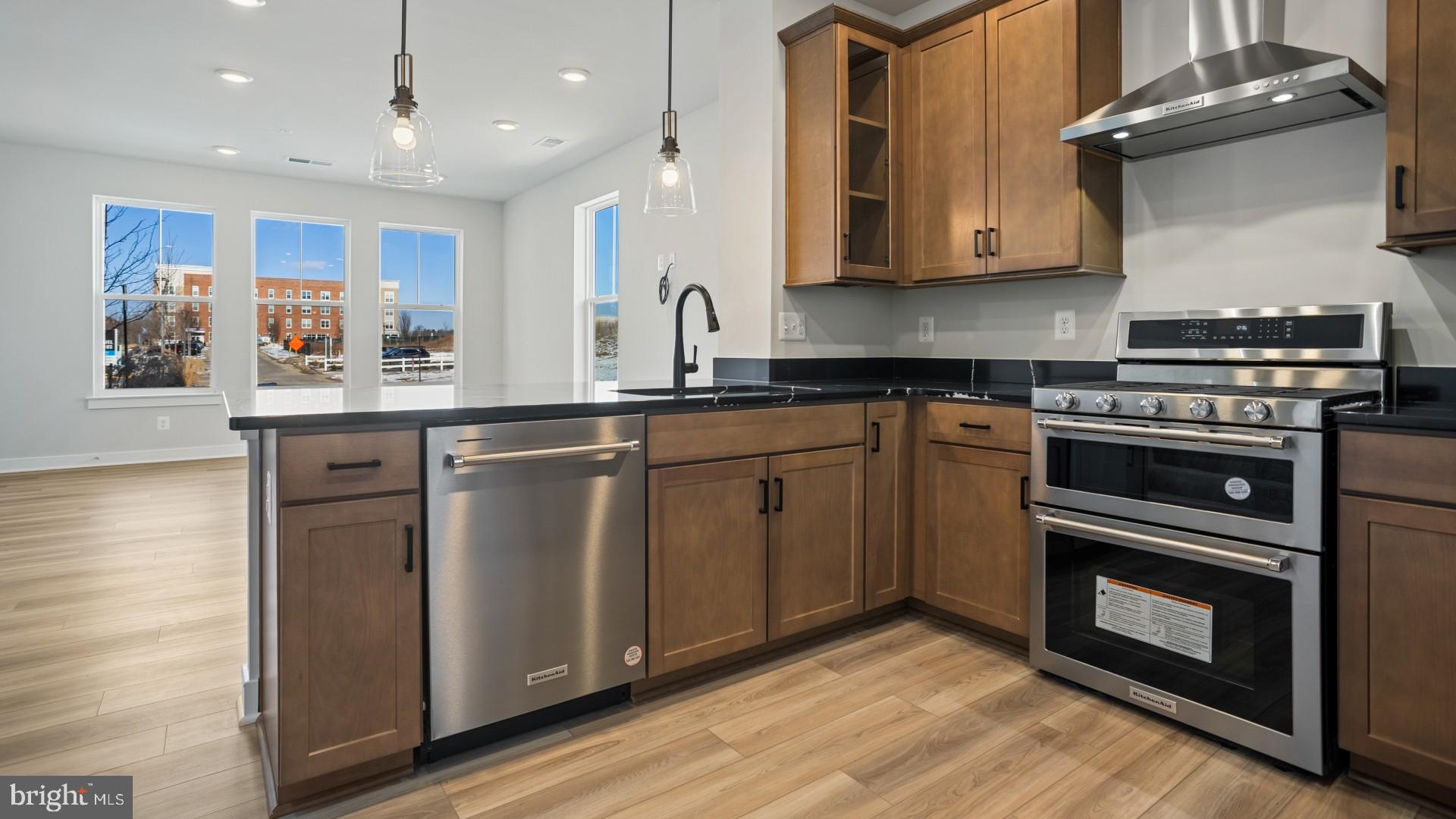 45176 Drowes Terrace Sterling, VA 20166 - Photo 2 of 15 a kitchen with stainless steel appliances granite countertop a stove a sink and a microwave
