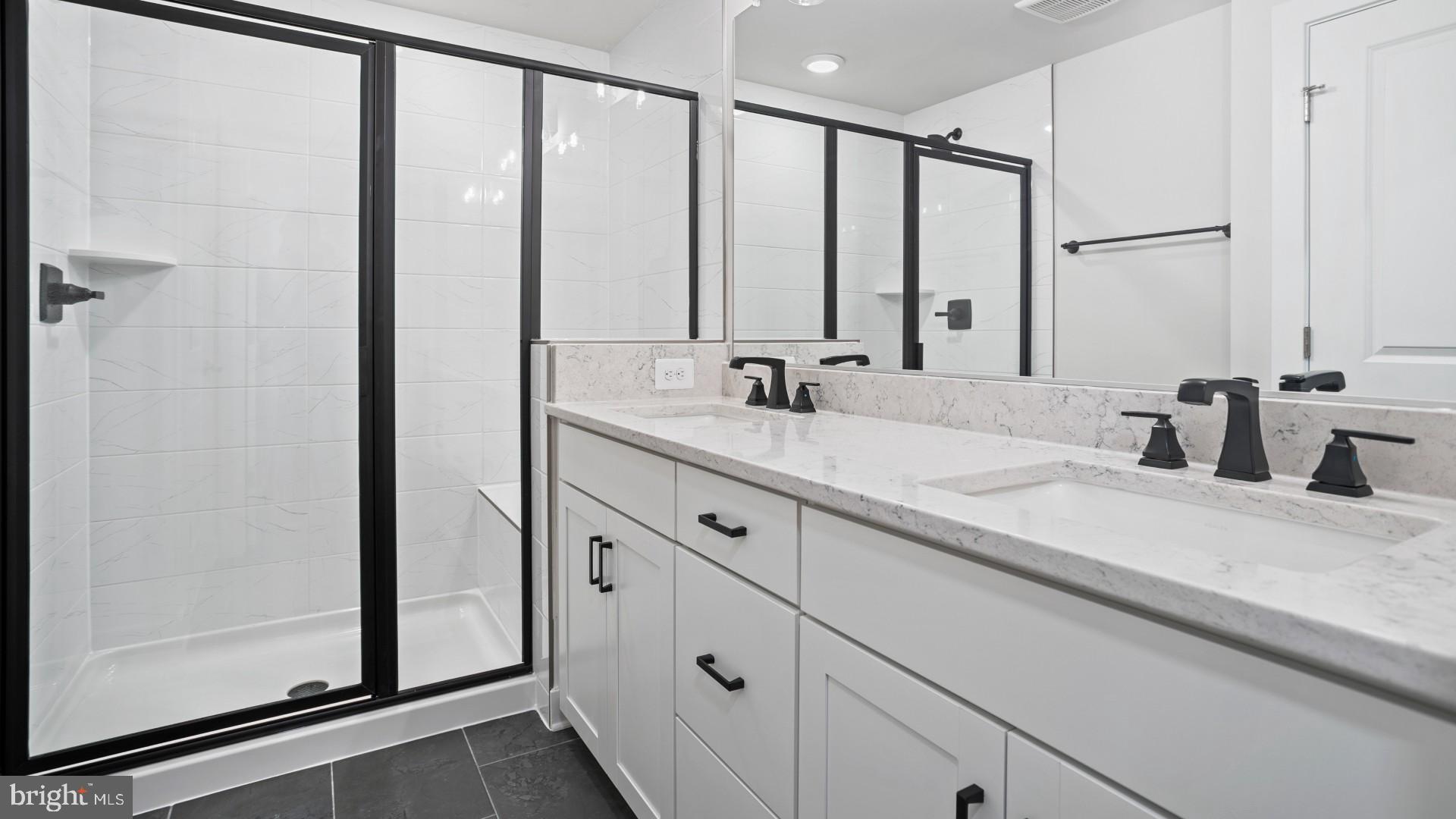 45176 Drowes Terrace Sterling, VA 20166 - Photo 8 of 15 a bathroom with a double vanity sink and mirror