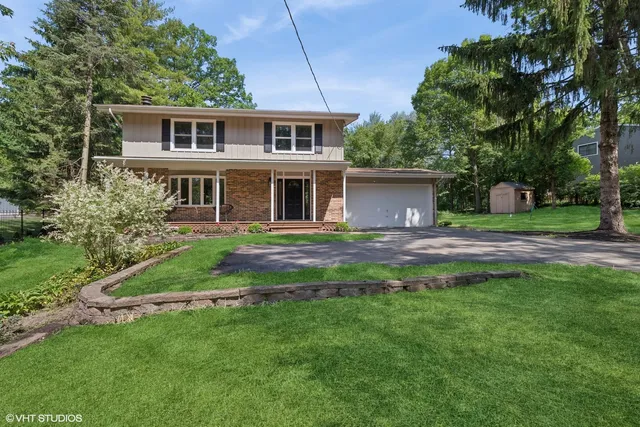 a front view of house with yard and green space