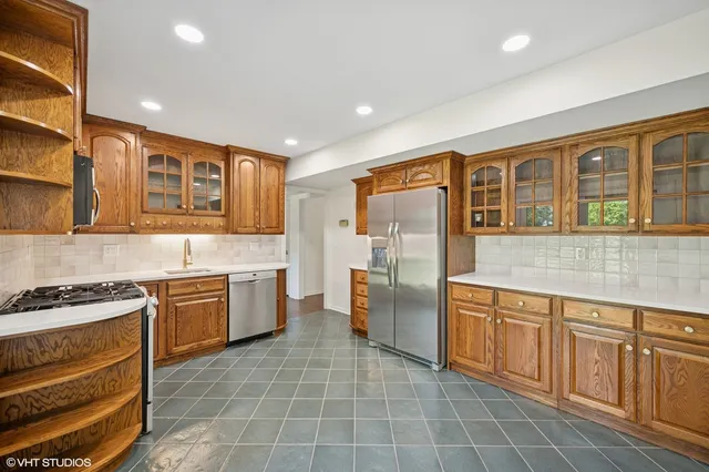 a kitchen with a stove sink and refrigerator