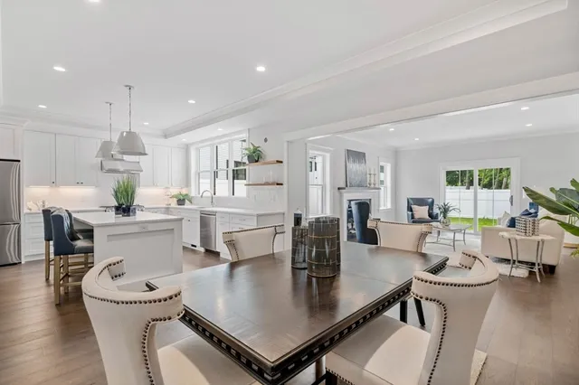 a kitchen with a table chairs and white cabinets