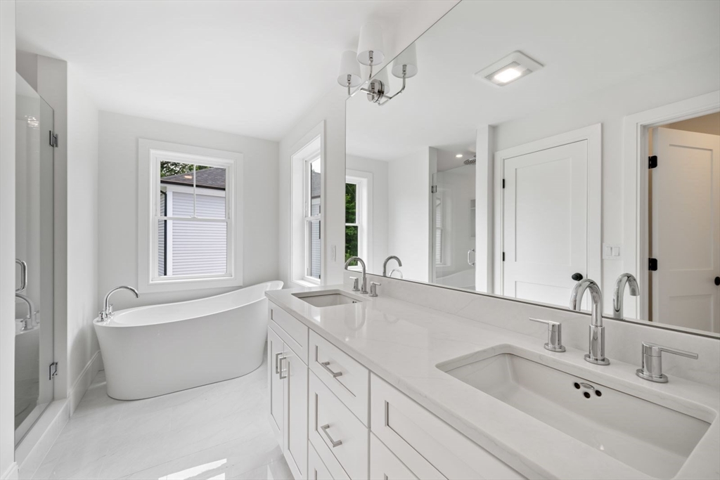 7 Milk Street Natick, MA 01760 - Photo 25 of 39 a bathroom with a sink double vanity mirror and a bathtub