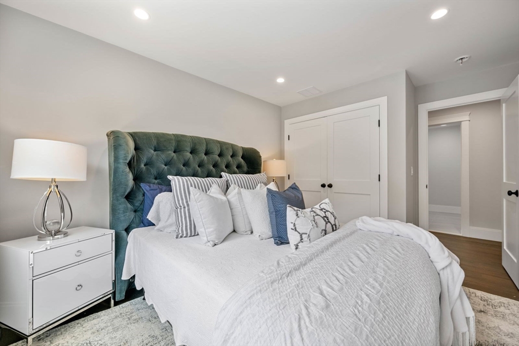 7 Milk Street Natick, MA 01760 - Photo 27 of 39 a bedroom with a bed and a lamp