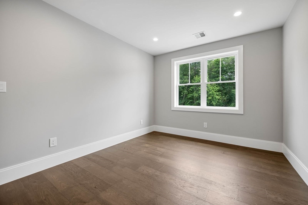 7 Milk Street Natick, MA 01760 - Photo 30 of 39 an empty room with wooden floor and windows