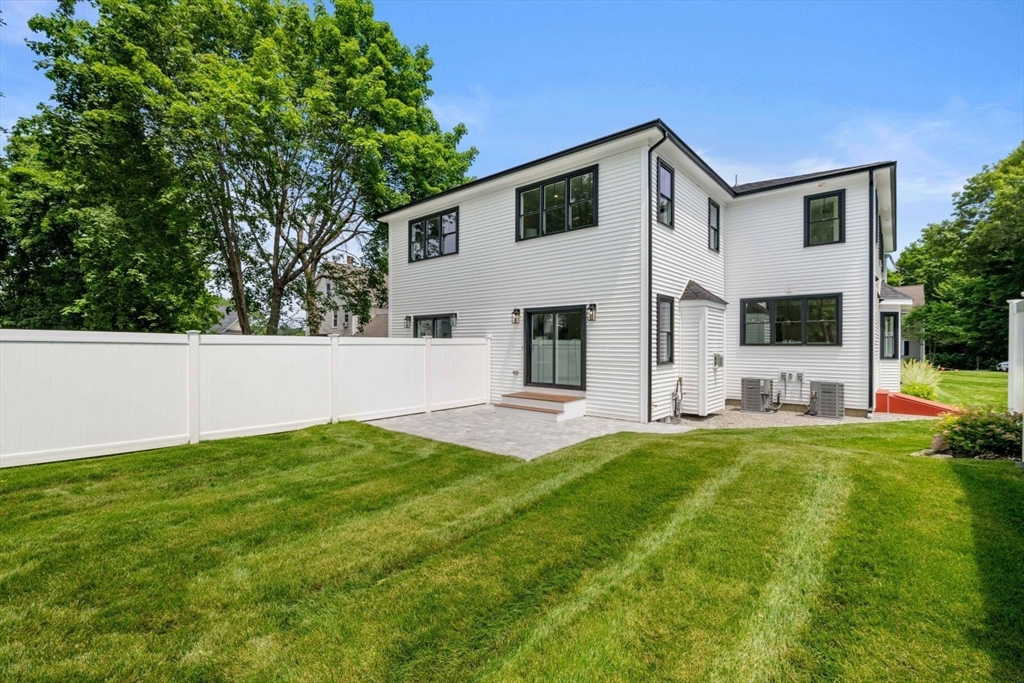 7 Milk Street Natick, MA 01760 - Photo 37 of 39 a front view of a house with a yard and garage