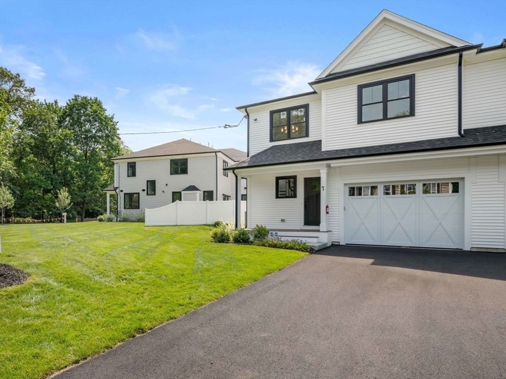 7 Milk Street Natick, MA 01760 - Photo 39 of 39 a front view of a house with a yard and garage
