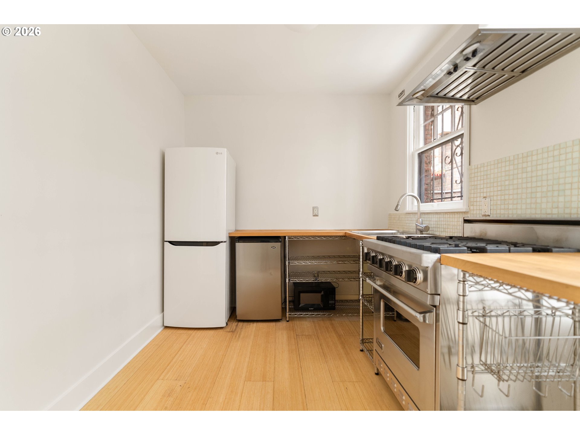 2182 Northwest Hoyt Street, Unit 8 Portland, OR 97210 - Photo 17 of 26 a kitchen with a refrigerator and a stove