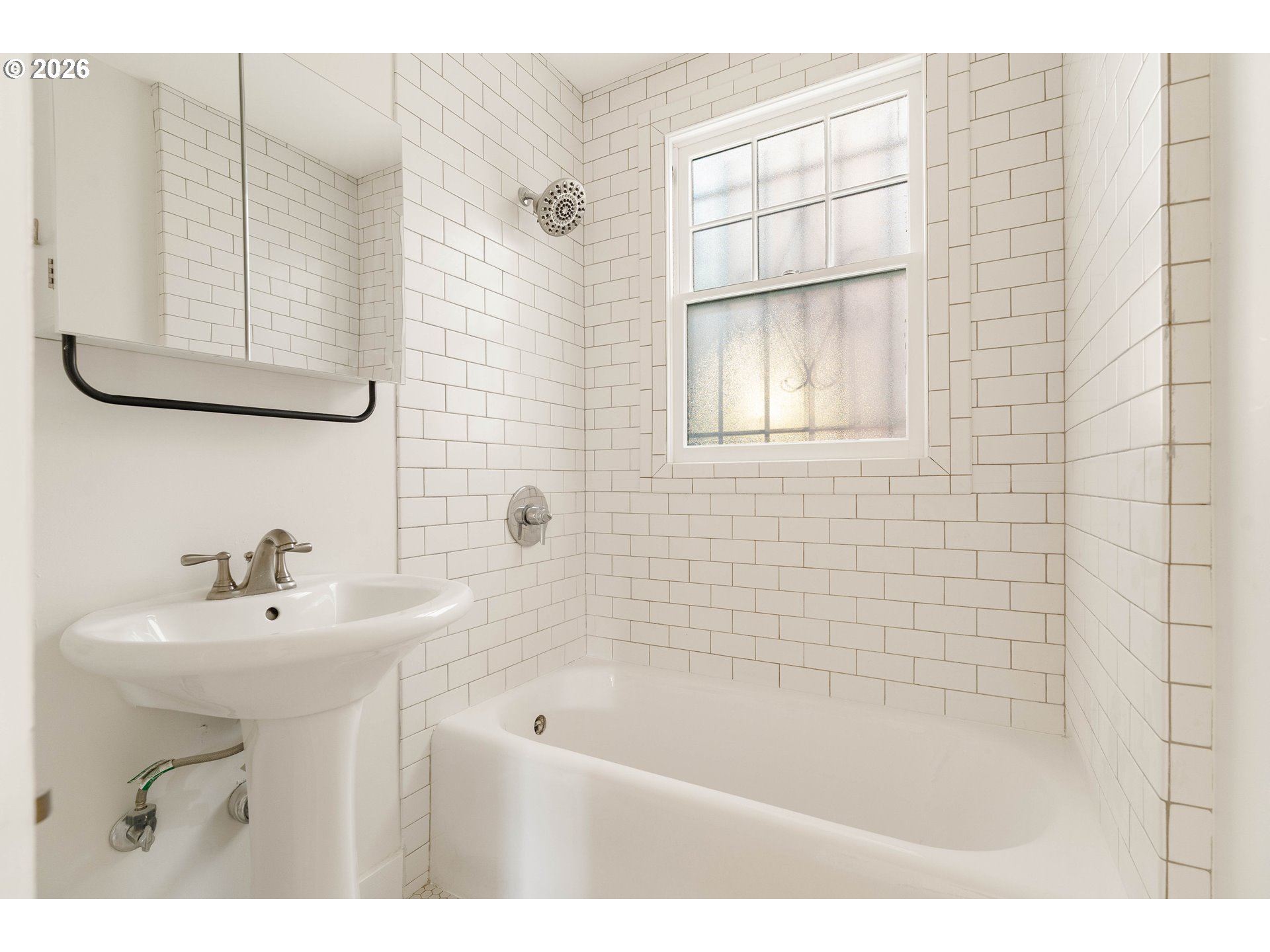 2182 Northwest Hoyt Street, Unit 8 Portland, OR 97210 - Photo 18 of 26 a bathroom with a sink a mirror and a bathtub