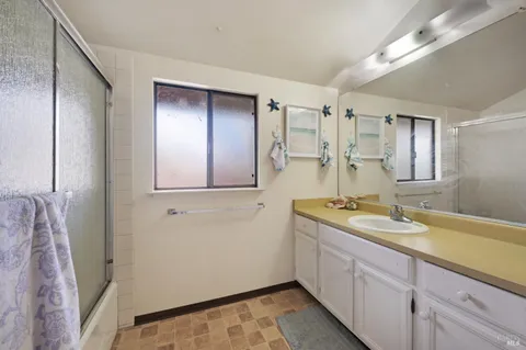 a bathroom with a bathtub and shower