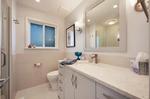 a bathroom with a sink a toilet and mirror