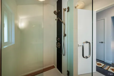a bathroom with a glass shower door