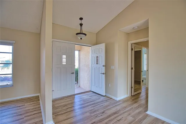 a view of a hallway with wooden floor