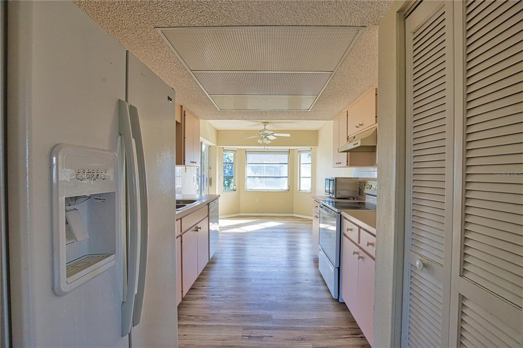 5847 Buchanan Road Venice, FL 34293 - Photo 13 of 47 a kitchen with granite countertop a refrigerator and a sink