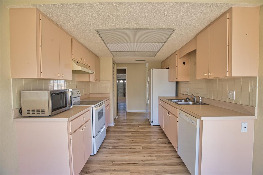 5847 Buchanan Road Venice, FL 34293 - Photo 17 of 47 a kitchen with stainless steel appliances a sink stove top oven and cabinets