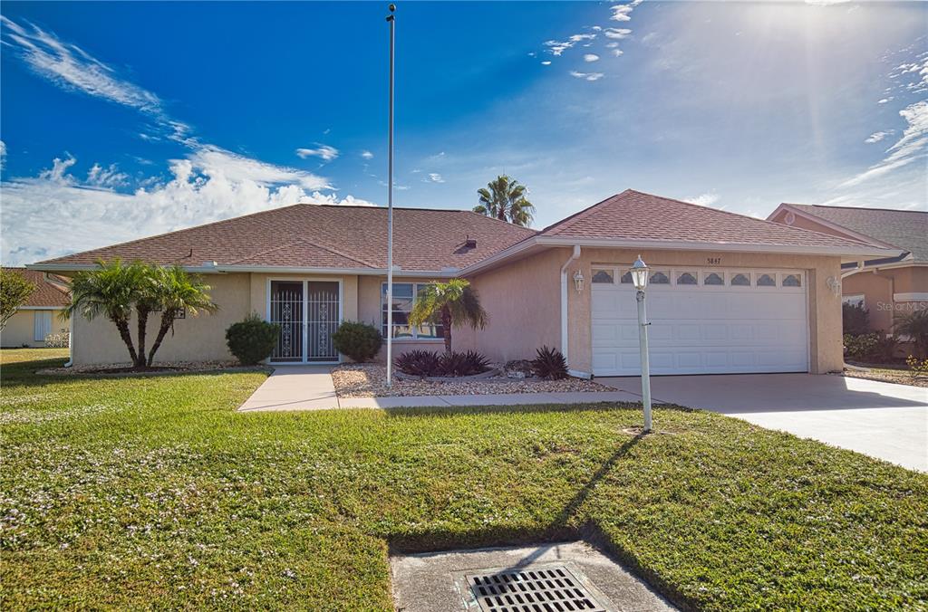 5847 Buchanan Road Venice, FL 34293 - Photo 2 of 47 a front view of a house with garden