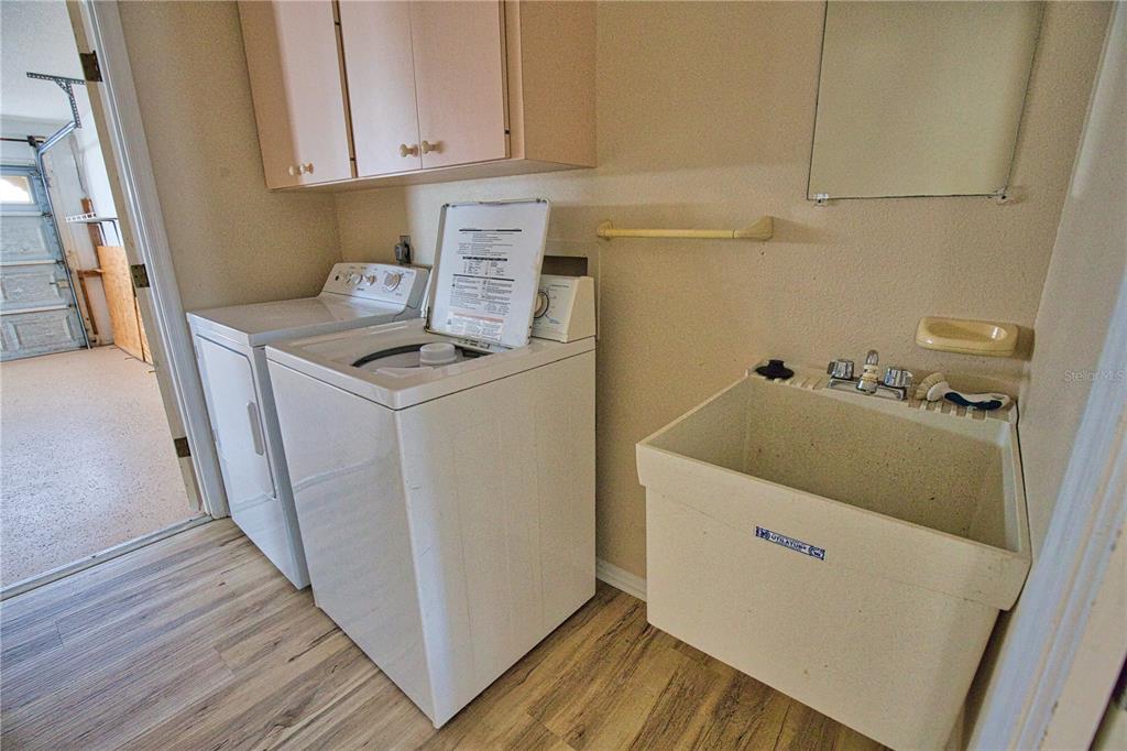 5847 Buchanan Road Venice, FL 34293 - Photo 21 of 47 a utility room with wooden floor washer and dryer