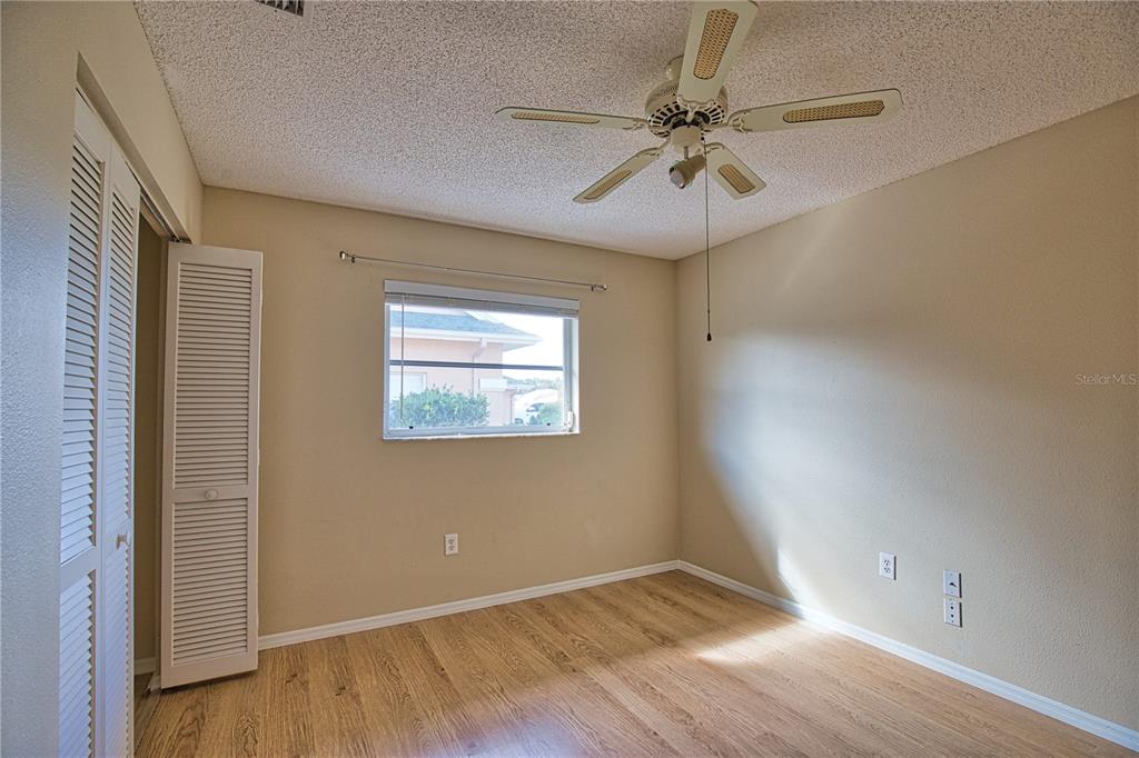 5847 Buchanan Road Venice, FL 34293 - Photo 23 of 47 an empty room with wooden floor fan and windows
