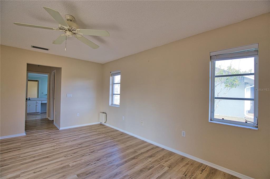 5847 Buchanan Road Venice, FL 34293 - Photo 26 of 47 a view of an empty room with a window and wooden floor