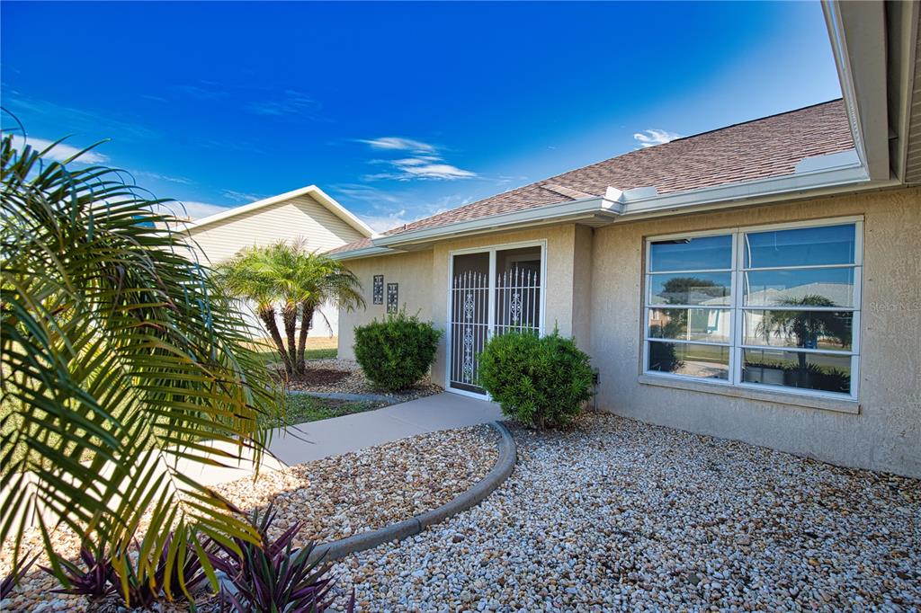 5847 Buchanan Road Venice, FL 34293 - Photo 3 of 47 a front view of a house with garden