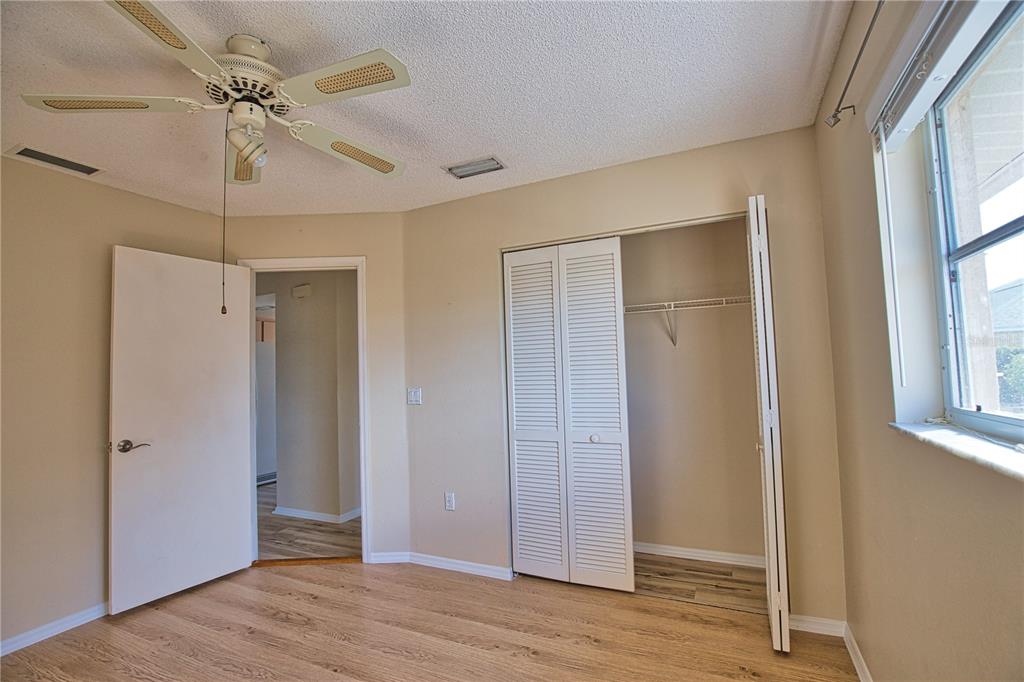 5847 Buchanan Road Venice, FL 34293 - Photo 39 of 47 a view of empty room with wooden floor and fan