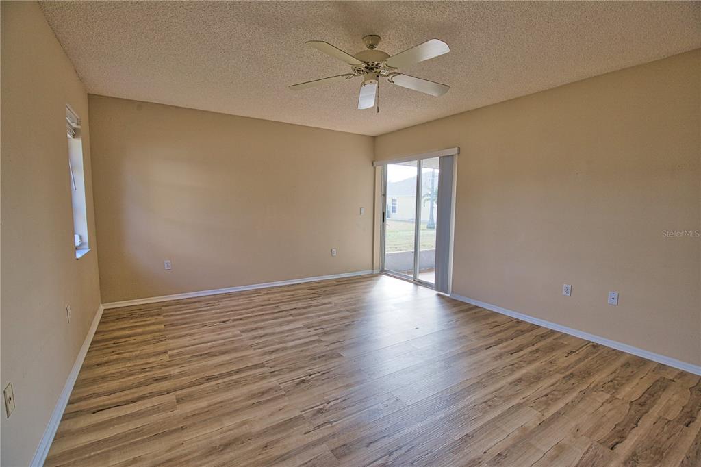 5847 Buchanan Road Venice, FL 34293 - Photo 40 of 47 a view of an empty room with a window and wooden floor
