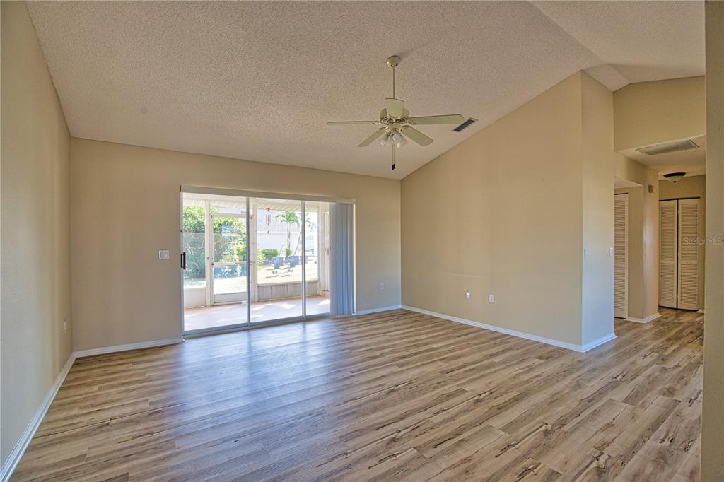 5847 Buchanan Road Venice, FL 34293 - Photo 4 of 47 a view of an empty room with wooden floor and a window