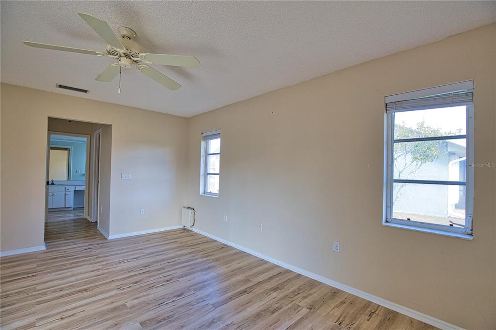5847 Buchanan Road Venice, FL 34293 - Photo 42 of 47 a view of an empty room with wooden floor and a window
