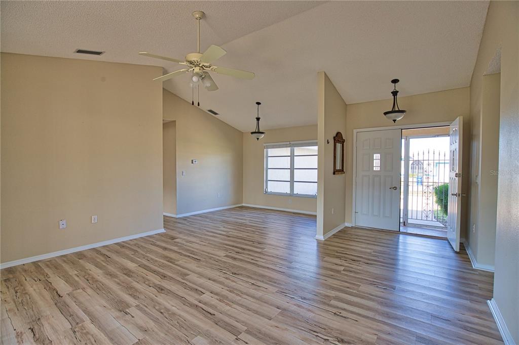 5847 Buchanan Road Venice, FL 34293 - Photo 5 of 47 a view of an empty room with wooden floor and a window
