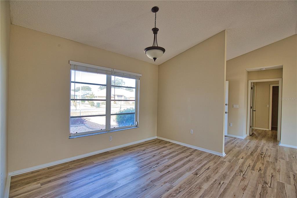 5847 Buchanan Road Venice, FL 34293 - Photo 8 of 47 a view of an empty room with wooden floor and a window