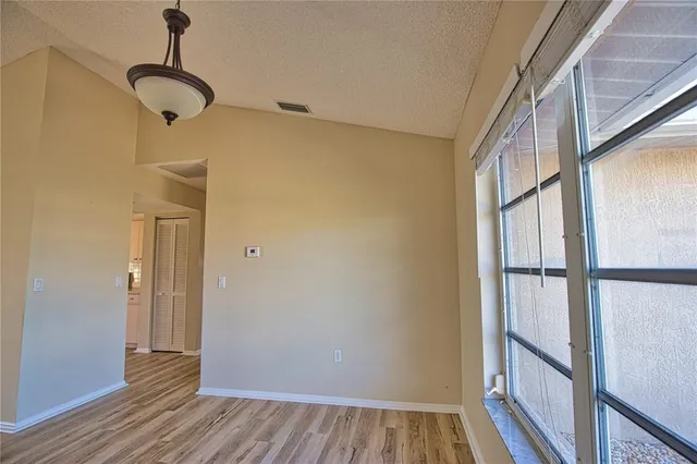 a view of a room with wooden floor and windows