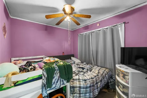 a bed sitting in a bedroom next to a window