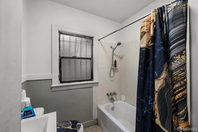 a bathroom with a bathtub and shower