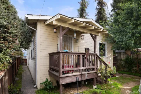 a view of a wooden house with a small yard