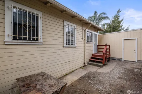 a backyard of a house with outdoor seating