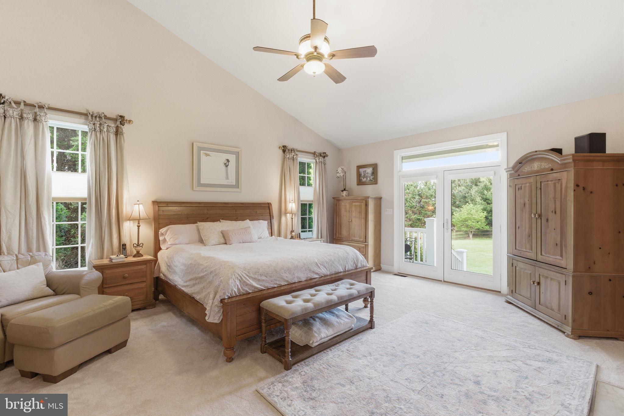 9 Deer Ridge Court Phoenix, MD 21131 - Photo 43 of 96 a spacious bedroom with a bed a couch and a chandelier