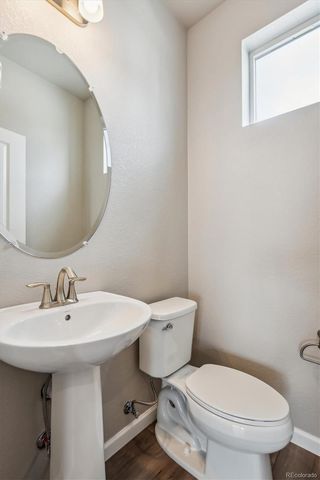 a white toilet sitting next to a bathroom sink