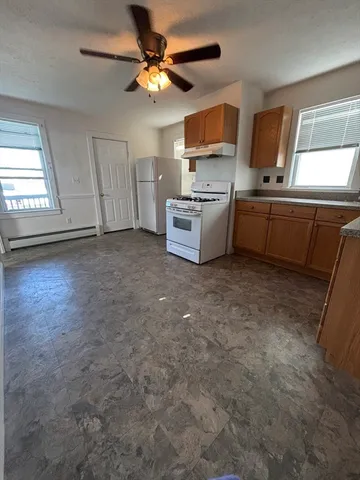 a kitchen with cabinets a sink and a stove top oven