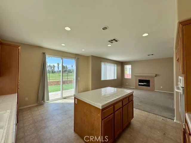 a view of kitchen with granite countertop cabinets and sink