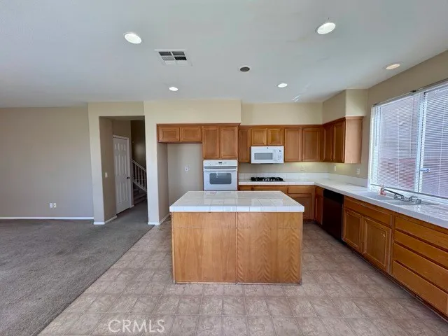a large kitchen with stainless steel appliances lots of counter top space