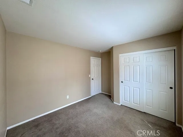 a view of an empty room and entryway