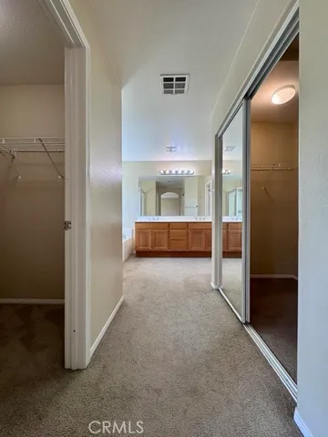 a spacious bathroom with a granite countertop sink a mirror and a bathtub