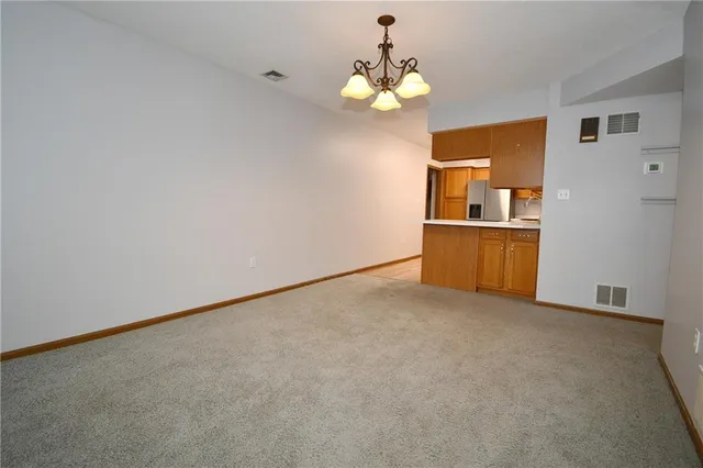 a view of a kitchen with a sink and cabinet