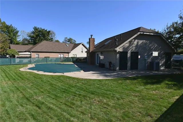a view of a bench in the backyard of a house