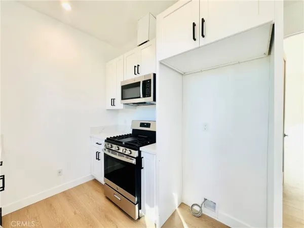 a kitchen with a sink and a stove top oven
